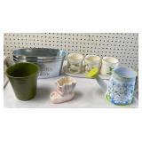 Lot of planters all different and watering can