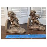 Pair Cherub bookends/door stops - 1 is quite