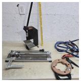 Jumper cables, tile cutter, fish tape, press