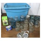 Tote full of assorted canning jars