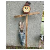 Hand painted scarecrow and rabbit for a garden.