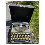 Remington typewriter in case (1924?). Has yellow