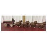 Cast iron wagon, clydesdales, and two figures
