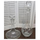 2 Decanters With Stoppers - The Shorter One Has A
