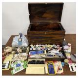 Wooden box filled with sewing accessories
