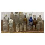 Assorted glass bottles, jars