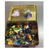 vintage Pokï¿½mon figures in a tin