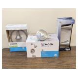 Moen showerhead, a Moen towel ring, and a Kohler