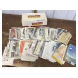 Assorted postcards in a cigar box *many not