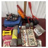 License plates, hand weights, cassette tapes on