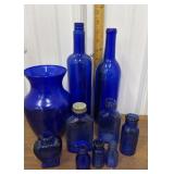 Blue glass bottles, vase
