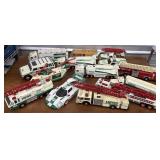 14 Hess trucks / toys - need cleaning. Dirty