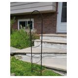Wire plant holder in front yard