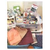 Large group of sewing and plastic tub of fabric