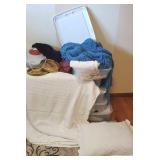 Pile - plastic tub with linens, sweaters, Prints,