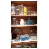 Shelves in kitchen cupboards of kitchenware