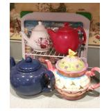 4 tea pots with cutting board and riser