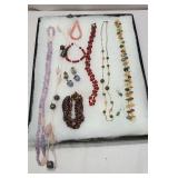 Case of jewelry - mostly necklaces including