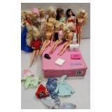 Group of Barbies with accessories and pink case