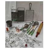 Group of utensils including red and green handles