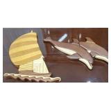 Wooden sailboat and dolphin plaques