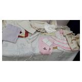 Box of linens including pink and white apron -