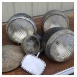 Old car headlights, mirror, hub cap, gas gauge