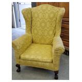 Yellow wingback chair with claw and ball feet