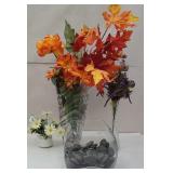 3 vases with floral arrangements and fish tank?