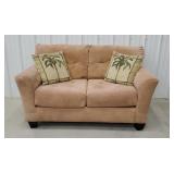 Tan loveseat with pillows -
Faded