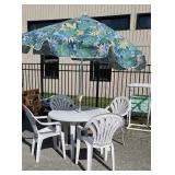 White plastic table with 4 chairs and umbrella