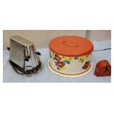 Retro tin cake carrier, old red clothes line, and