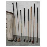 8 Wooden and fiberglass golf clubs with bag