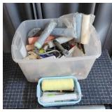 Large tote filled with assorted painting supplies.