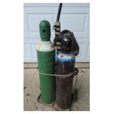 Oxy acetylene tank set mounted on a portable rolli