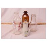 group of 4 milk bottles