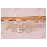 group of glass single serving creamer bottles