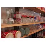 large group of coca cola drinking glasses