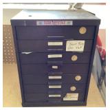 7-drawer metal cabinet full of watch crystals