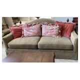 Plush sofa with accent pillows and finial back