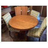 48" round oak pedestal table, 3 chairs, 2 leaves