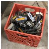 Milk crate full of bike pedals