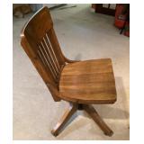 Vintage wooden office chair on wheels