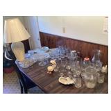 Glassware and lamp on table