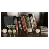 Contents of shelf with books and baseballs