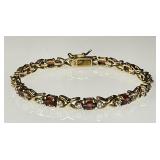 Gold over sterling tennis bracelet with garnet