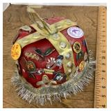 Plastic fez covered with buttons