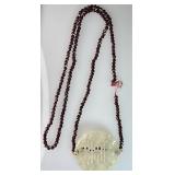 Carved jade pendant with garnet beads