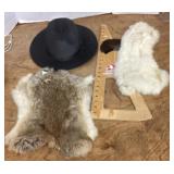 Menï¿½s straw hat and 2 rabbit pelts