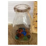 Small milk bottle with marbles